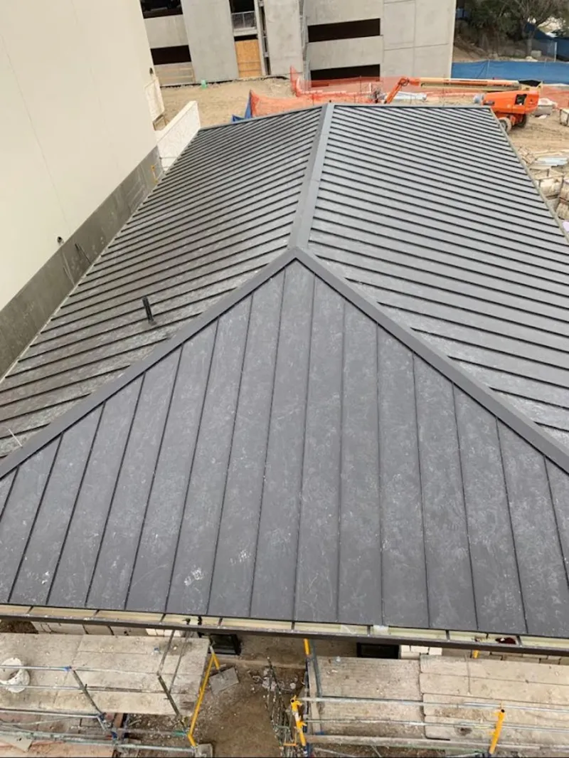 Commercial metal roof construction with crane equipment in St. Thomas