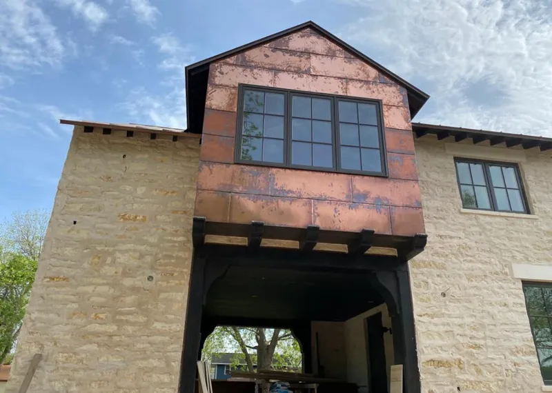 Copper metal panel facade on a stone building for Metal Roof Coating in St. Thomas